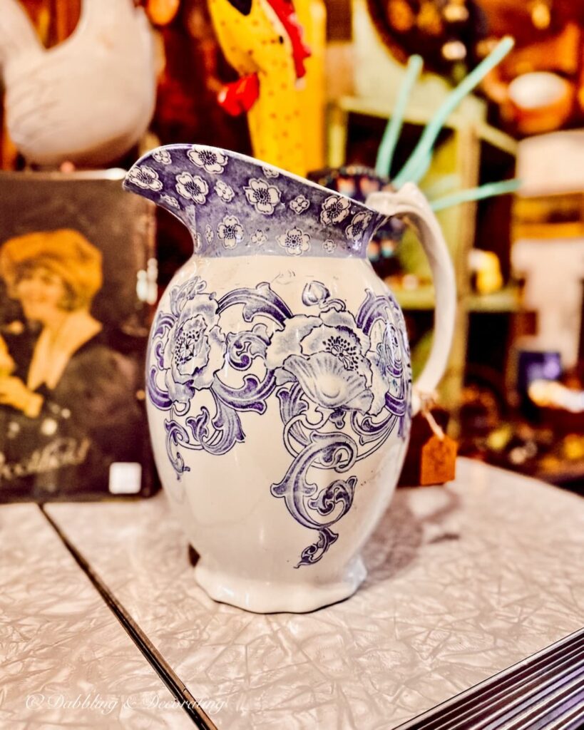 Purple and white large trasnferware pitcher in antique store.